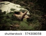 Lower body of abandoned murder victim in dark countryside with bare feet protruding