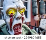 Small photo of Copenhagen, Denmark - Oct 21, 2018: Ghastly painted plastic zombie face displayed on the street in celebration of the Halloween festival. Close-up view.