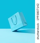 Small photo of Paper shopping bag on blue background. Shopping sale delivery concept