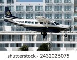 Small photo of St. Maarten, Netherlands Antilles - Jan 15 2024: A St Barth Commuter Cessna 208B Grand Caravan turboprop commuter plane, landing at the SXM Airport