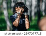 Female golfer looks into rangefinder and measures distance. Golfer holding ball and meter playing golf