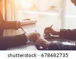 Businessperson Signing Contract about insurance, Two men writing with pen sign of modest agreements form In modern office, morning light, vintage color, success of business partners concept
