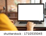 women using laptop computer working at home with blank white desktop screen.