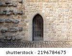 dark brown medieval castle wooden door, stone wall panorama