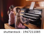 Two Little Girls Play The Organ ...