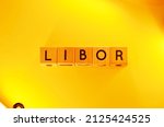 Small photo of LIBOR word text photo from wooden cube block letters isolated on yellow background. LIBOR is the acronym for London Interbank Offer Rate.