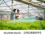 5G technology trend and smart farm agriculture concept.Farmer use ai drone and robot farmers (automation) to monitor check the health of Hydroponics plant.Agriculture drone fly for research analysis.