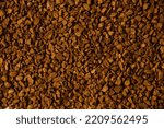 Small photo of A scattering of instant freeze-dried coffee occupying the entire frame. Brown background. Structure of instant coffee.