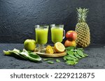 Green Juice. Colored juice. Fruit and vegetable juice, made from a mixture of fruit and vegetables, processed with a slow juicer. Served in a glass. Selective focus
