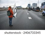 Small photo of Amsterdam,The Netherlands,30th december,2023.Extinction rebellion blocked the A10 highway to protest against investments by ING in polluting projects. Police removed and arrested a few hundred people.
