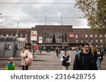 Small photo of DUSSELDORF, GERMANY - NOVEMBER 7, 2022: Passengers walking by the main facade of Dusseldorf Hbf, or Dusseldorf Hauptbahnhof, the main railway hub of the german city.