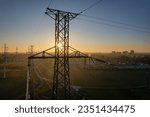 Small photo of Power tower with electricity. Energy and high voltage electricity pylon at Sunset or golden hour. Power demand and outage blackout concept due EV or electrical vehicle increase. Grid infrastructure.