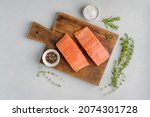 Fresh raw scandinavian salmon fillet. Rosemary and thyme. Salt and pepper. On old wooden board. Pescetarian seafood for cooking. Preparation nutrition seafish. Horizontal, top view