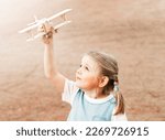 Cute girl playing with wooden airplane