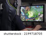 Small photo of Santos, Brazil - September 7, 2022: Gamer man playing League of Legends video game on PC. League of Legends is a online multiplayer battle arena developed by Riot Games. Playing with annie in mid lane