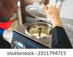 Small photo of Ice cream pasteurization machine rotating with closed lid to pasteurize icecream. High quality photo