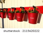 Red Fire Buckets With Flowers....
