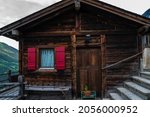 Beautiful traditional wooden houses in the streets of the alpine village Orsieres, Switzerland, in the canton Valais. Aged wood cottage. Old vintage architecture.