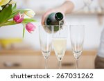 Pouring champagne in flutes standing on table