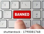 admin bans the user. The red button on the keyboard of a notebook with the inscription of banned. The concept of blocking in the Internet