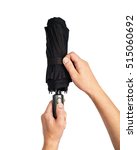 Small photo of man hand with an black automatic umbrella isolated on white background, Human hand holding a bumbershoot