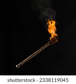 burning wooden torch isolated on black background