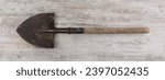 Small photo of bayonet shovel on wooden background