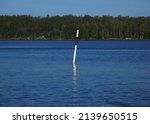 Small photo of Black and white spar buoy (navigation sign). Dramatic sky. Sailing on Lake Melaren, Finland, Scandinavia. Nature, environment