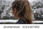 Small photo of Girl from behind winter snow. Primer plano chica en la nieve de espaldas