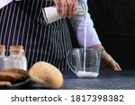 Chef is Pouring Milk into The Measuring Cup