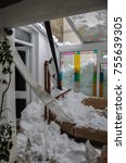 Small photo of Snow damage inside a home after thick icy snow slid of a roof and crashed through a conservatory.