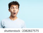 Portrait of excited positive teenage boy looking away isolated on blue background. Concept of shopping, discounts, sales, advertisement