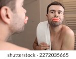 Comedic image of man looking at his enlarged lips 