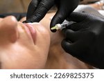 Small photo of Doctor cosmetologist with syringe makes injection of botulinum toxin into chin of unrecognized female patient in cosmetology clinic, beauty treatment in cosmetology. Horizontal plane.