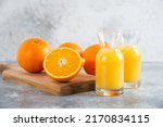 Small photo of front view fresh sliced orange on marble background ripe mellow fruit juice color citrus tree citrus, Whole and sliced ripe oranges placed on marble background, half orange fruit.