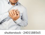 Small photo of the man pressed his chest with a painful expression. Severe heartache, having a heart attack or painful cramps, heart disease