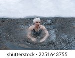 young caucasian girl swimming in cold water in winter, healthy lifestyle, tempering concept