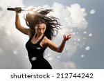 Beautiful aggressive Brunette holding katana sword with cloudy environment