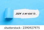 Small photo of Words 2024 is my year to on white background and torn blue paper. 2024 new year torn paper concept