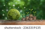 Small photo of Green business concept, finance and investment for sustainability and carbon credit. Green Globe with icon and stack of silver coins the seedlings are growing on top. ESG, co2 and green tax.