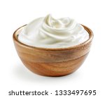 Sour cream or yogurt in wooden...