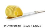 Small photo of curl of fresh butter on a knife isolated on white background