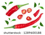sliced red hot chili pepper decorated with green leaves isolated on white background. Top view. Flat lay pattern