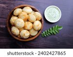Small photo of Paniyaram are savory balls made using fermented rice and urad dal batter along with tempered onion and spices. Also known as Paddu, Ponganalu, Kuli, bugga, and appe. served with coconut chutney