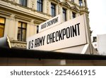 Small photo of Signpost at Checkpoint Charlie. The crossing point between East and west Berlin, symbol of the Cold War.