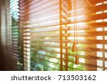 Wooden shutters blinds with sun rays. Window blinds. 