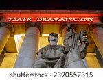 Small photo of Warsaw, Poland - September 6 2022: Entrance into Dramatic theatre, part of Palace of Culture and Science. Teatr Dramatyczny red neon light. Statue under the columns. Dramatic night scene.