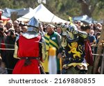 Small photo of South Australia, Gumeracha Medieval Fair, May 2021: Knights in metal helmets and armour with swards fight, a part of a costume performance at a medieval fair, reconstruction of knightly battles.