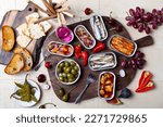 Tinned fish charcuterie board. Seacuterie appetizers platter with canned fish and seafood. Food trend for party and tinned fish date night