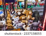 Fairground attraction catching stuffed toys